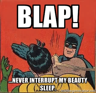 Batman slaps Robin for interrupting his beauty sleep.
